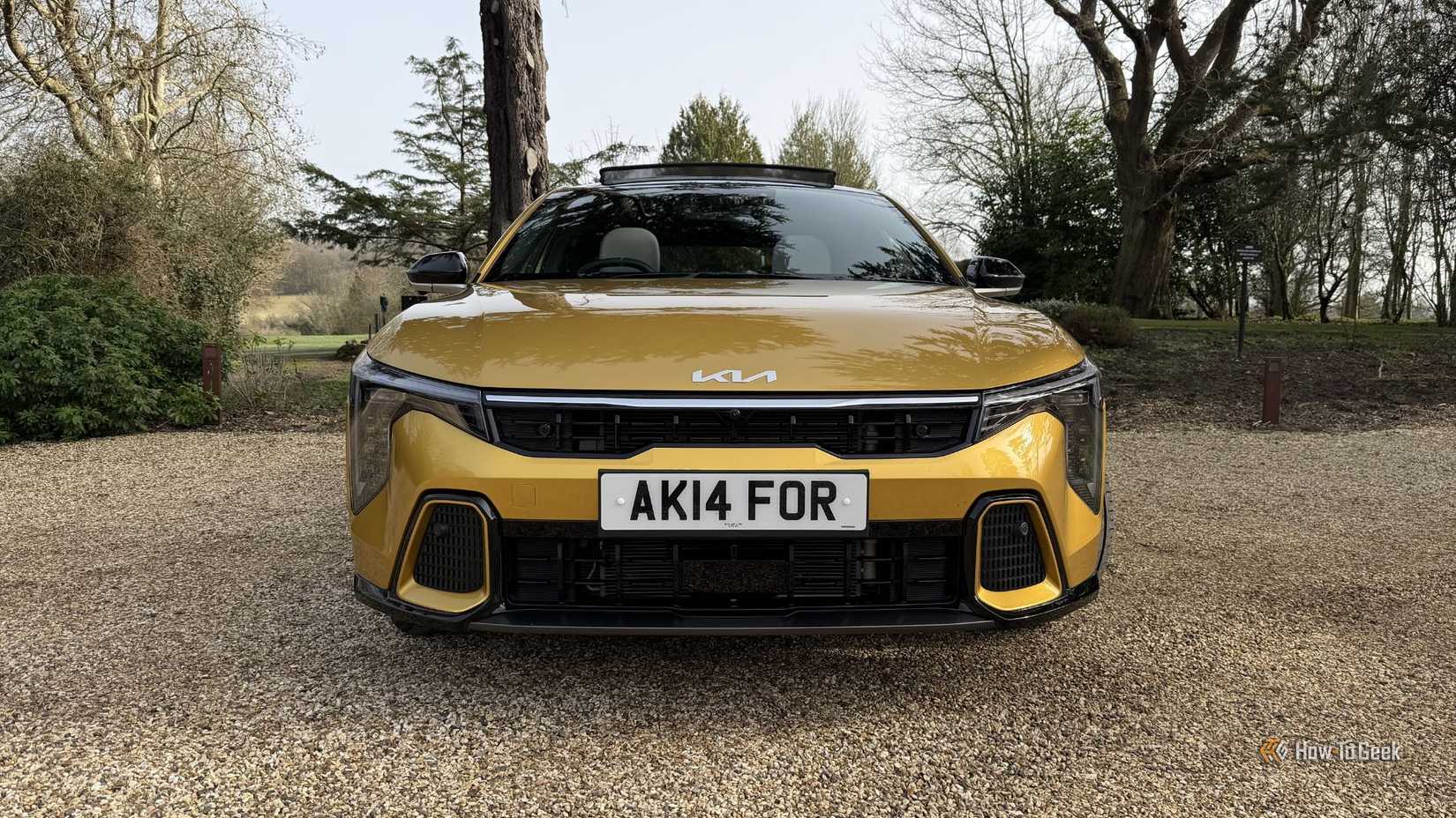 Static front-end shot of a yellow 2026 Kia K4 Hatchback.