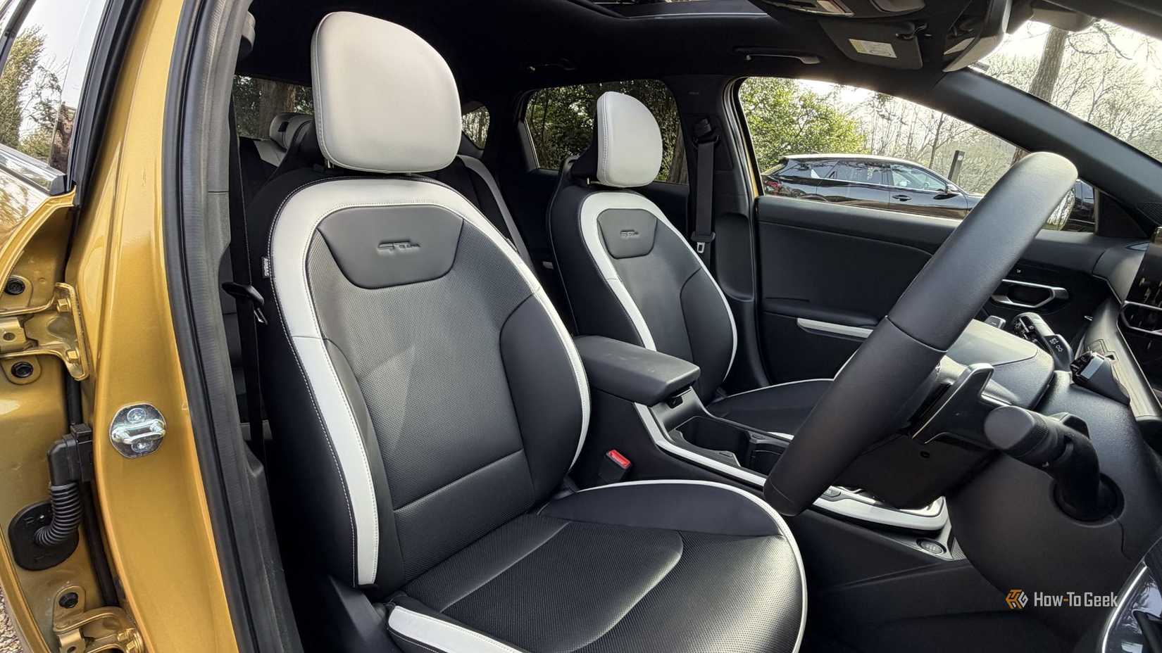 Shot of the black and white leather front seats inside the cabin of a 2026 Kia K4 Hatchback.