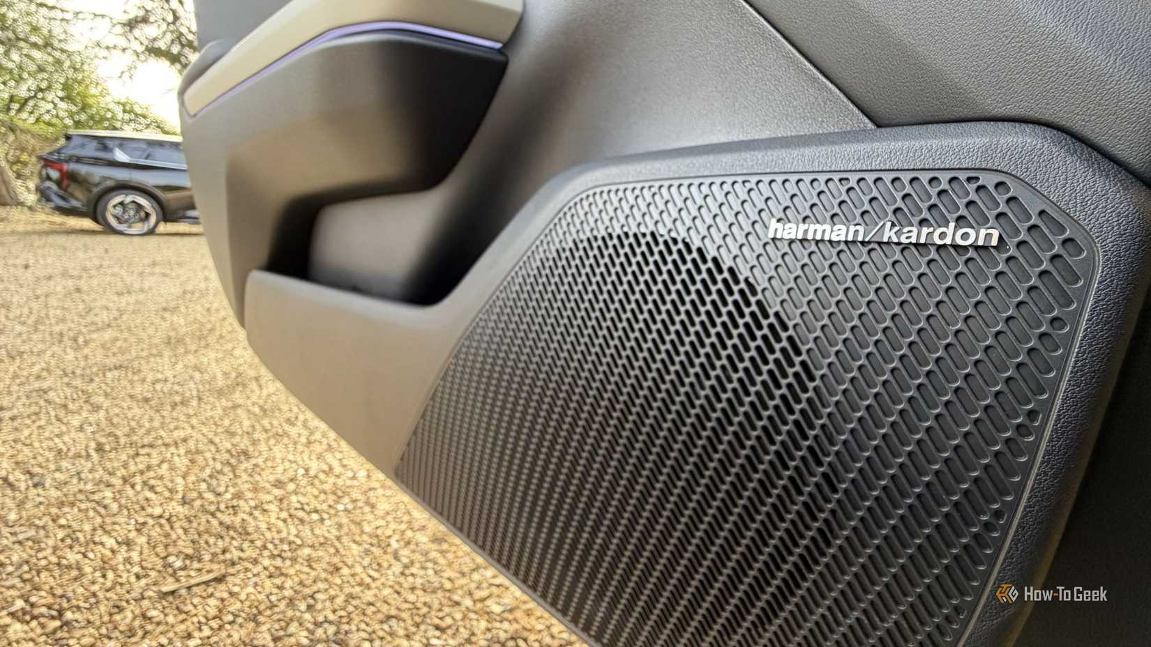 Close-up shot of the Harman Kardon door speaker in a 2026 Kia K4 Hatchback.