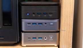 A cluster of three mini PCs stacked on top of each other for high availability.