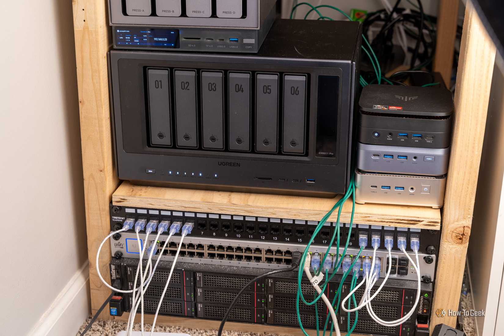 A homelab shelf with a Ugreen NAS, mini PCs, a network switch, and rack servers.