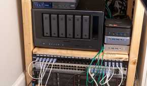 A homelab shelf with a Ugreen NAS, mini PCs, a network switch, and rack servers.