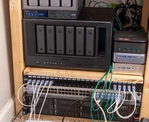 A homelab shelf with a Ugreen NAS, mini PCs, a network switch, and rack servers.