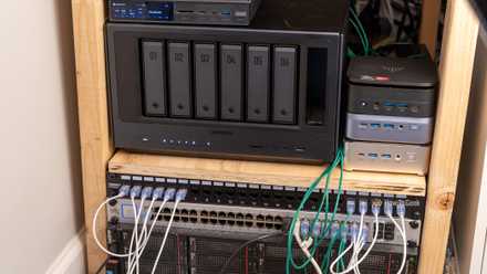 A homelab shelf with a Ugreen NAS, mini PCs, a network switch, and rack servers.