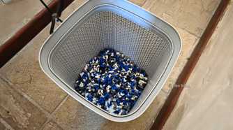 A plastic wastepaper basket full of PLA purges.
