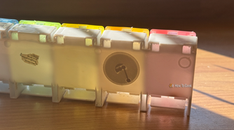An NFC tag sticker on the back of a medication storage box.