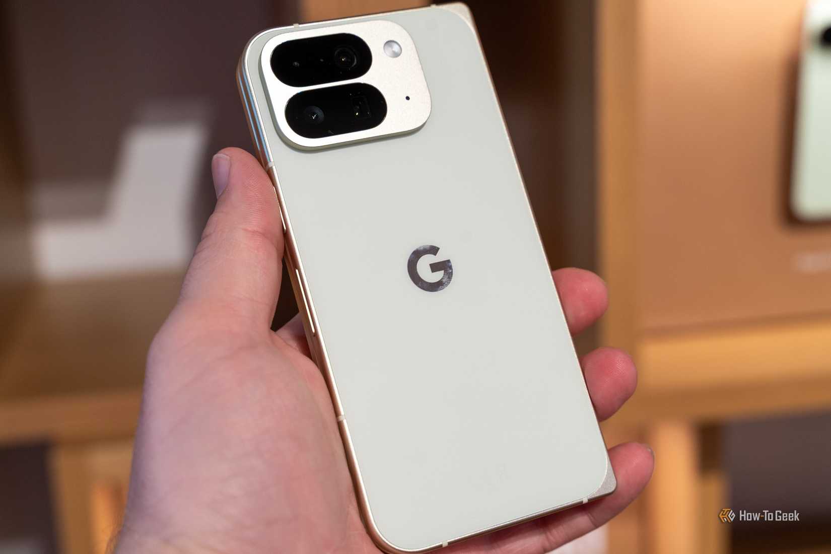 Close-up of a light-colored Google Pixel 10 Pro Fold held in a hand.