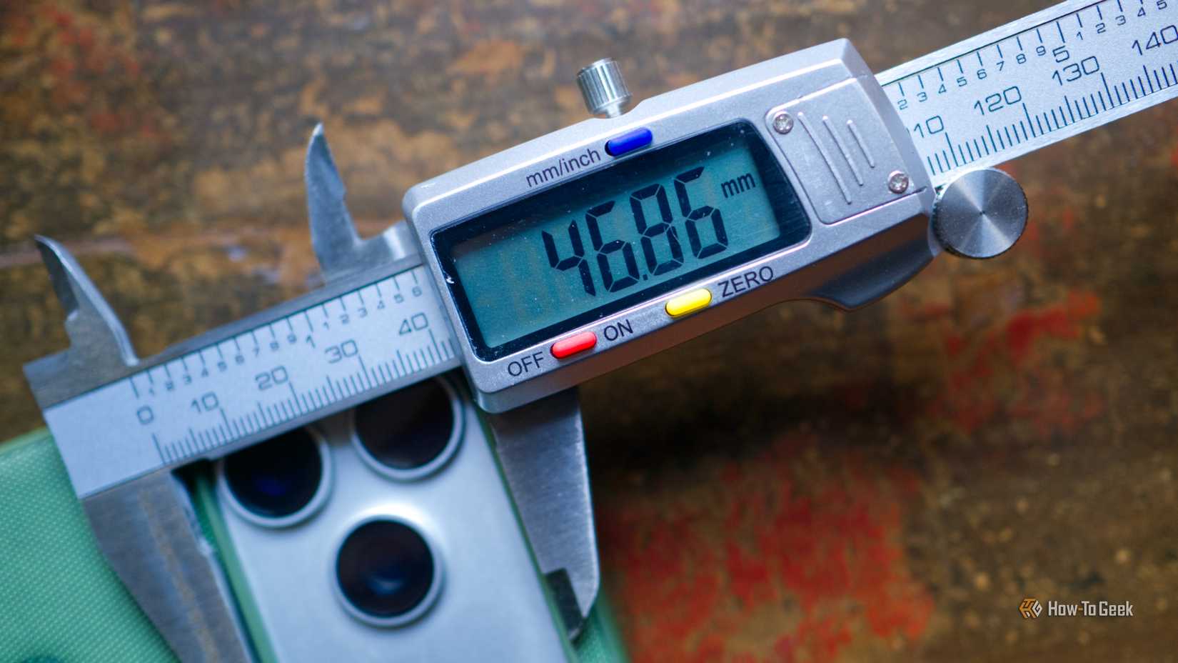 Digital caliper measuring the back of an iPhone case in mm.