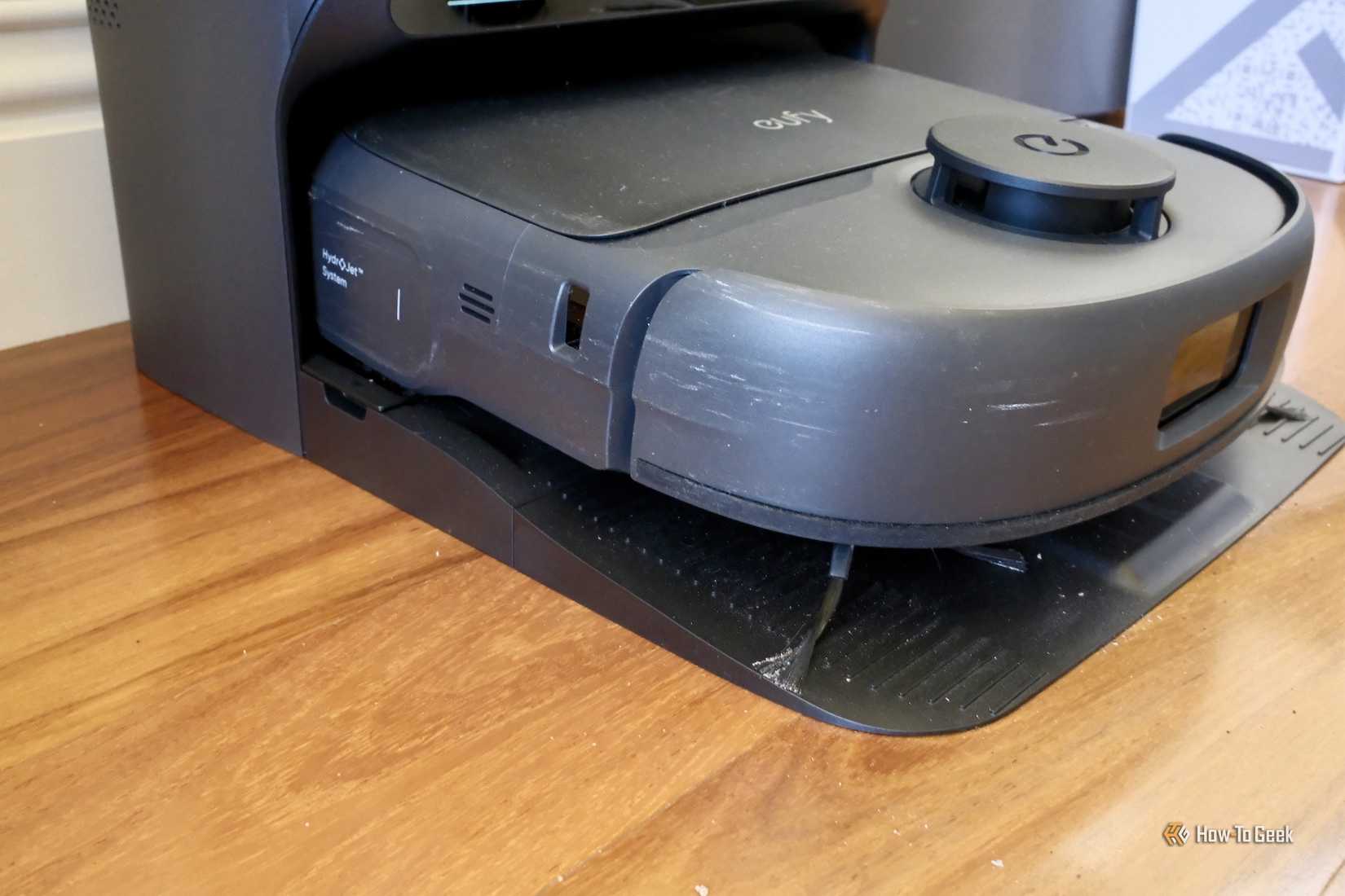 Side view of Eufy Omni C28 charging after cleaning.