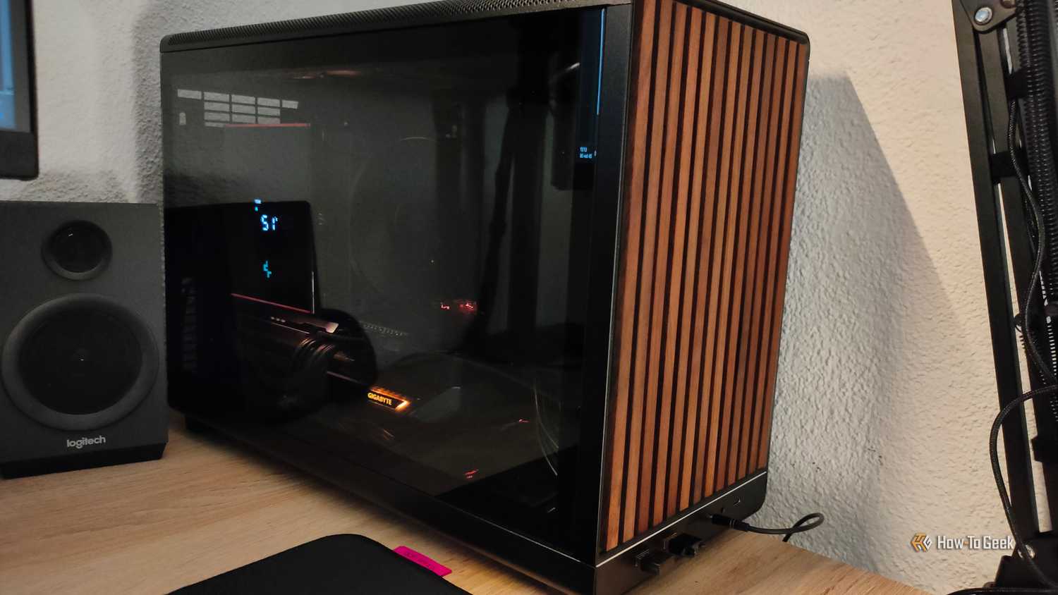 An ITX PC tower stands next to a PC speaker.