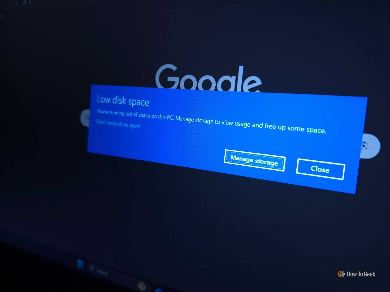 A screenshot of the Windows dialog box showing low disk space over a Google logo
