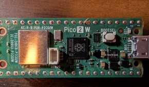 Top-down shot of a Pico 2 W with GPIO header.