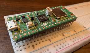 The Pico 2 W barely attached to a breadboard.