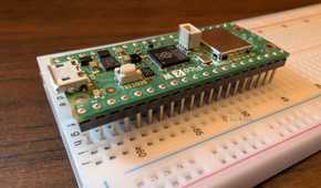 The Pico 2 W sitting on a breadboard.
