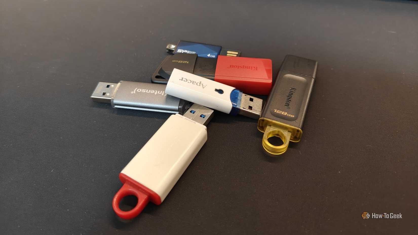 Several USB flash drives stacked on top of each other.