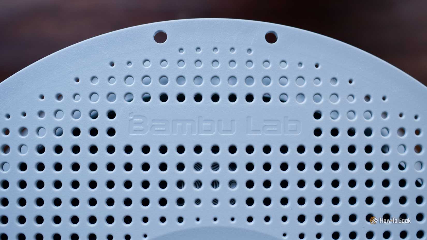 A spool of 3D printer filament with the Bambu Lab logo visible.