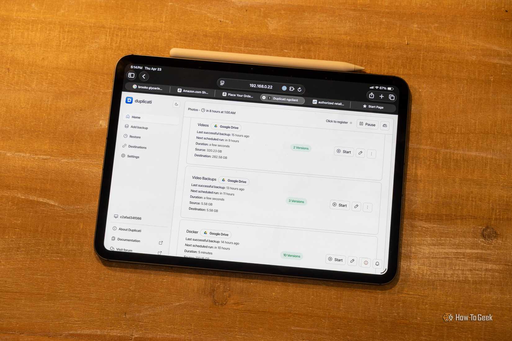 Duplicati's backup interface on an iPad Pro sitting on a wooden background. 