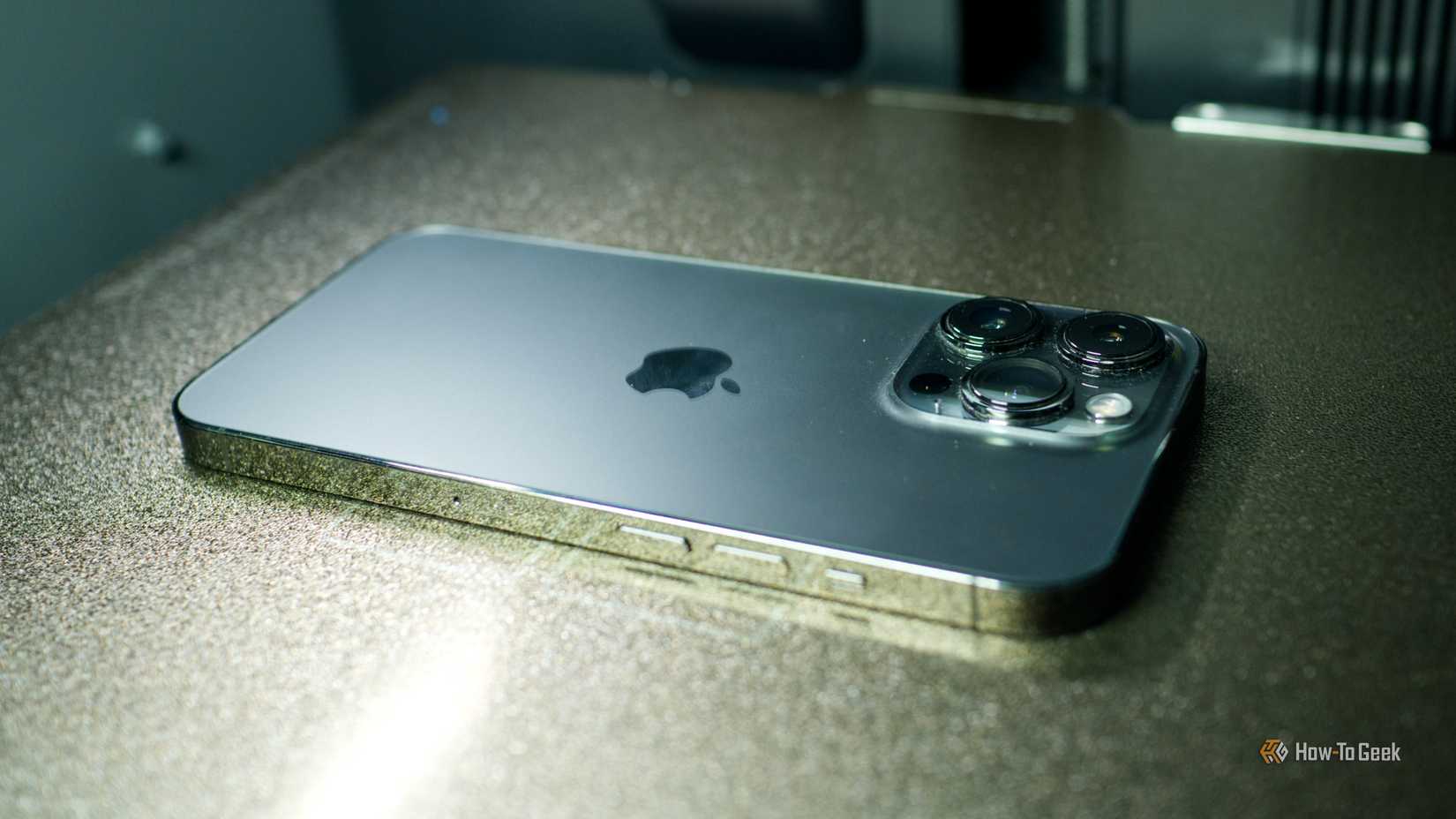 An iPhone 13 Pro face down on a Bambu Lab P2S printing platform.
