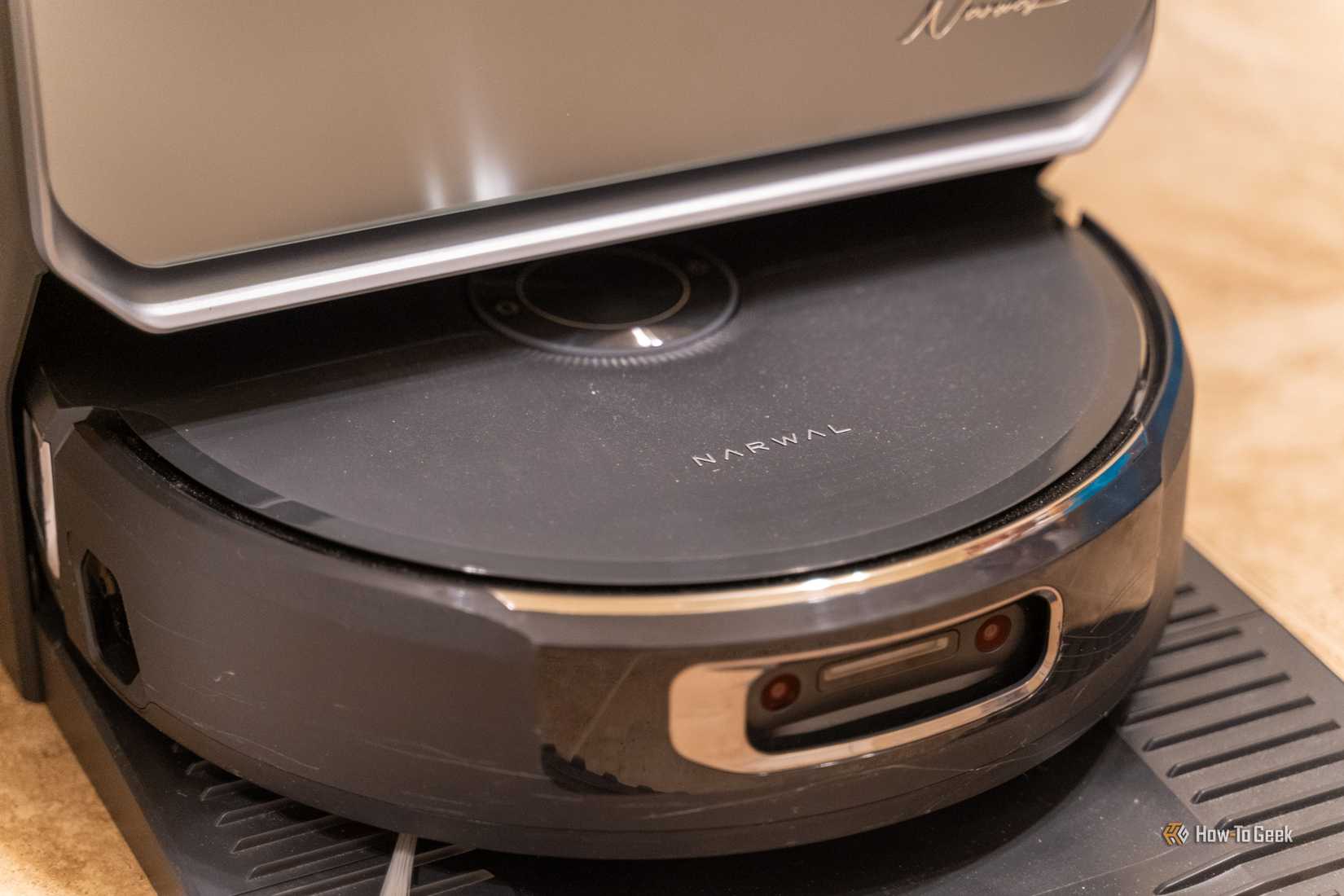 Close-up of the Narwal Flow 2 robot vacuum front sensors while docked.