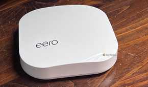 An image of a white eero Mesh Wi-Fi router on a walnut tabletop.