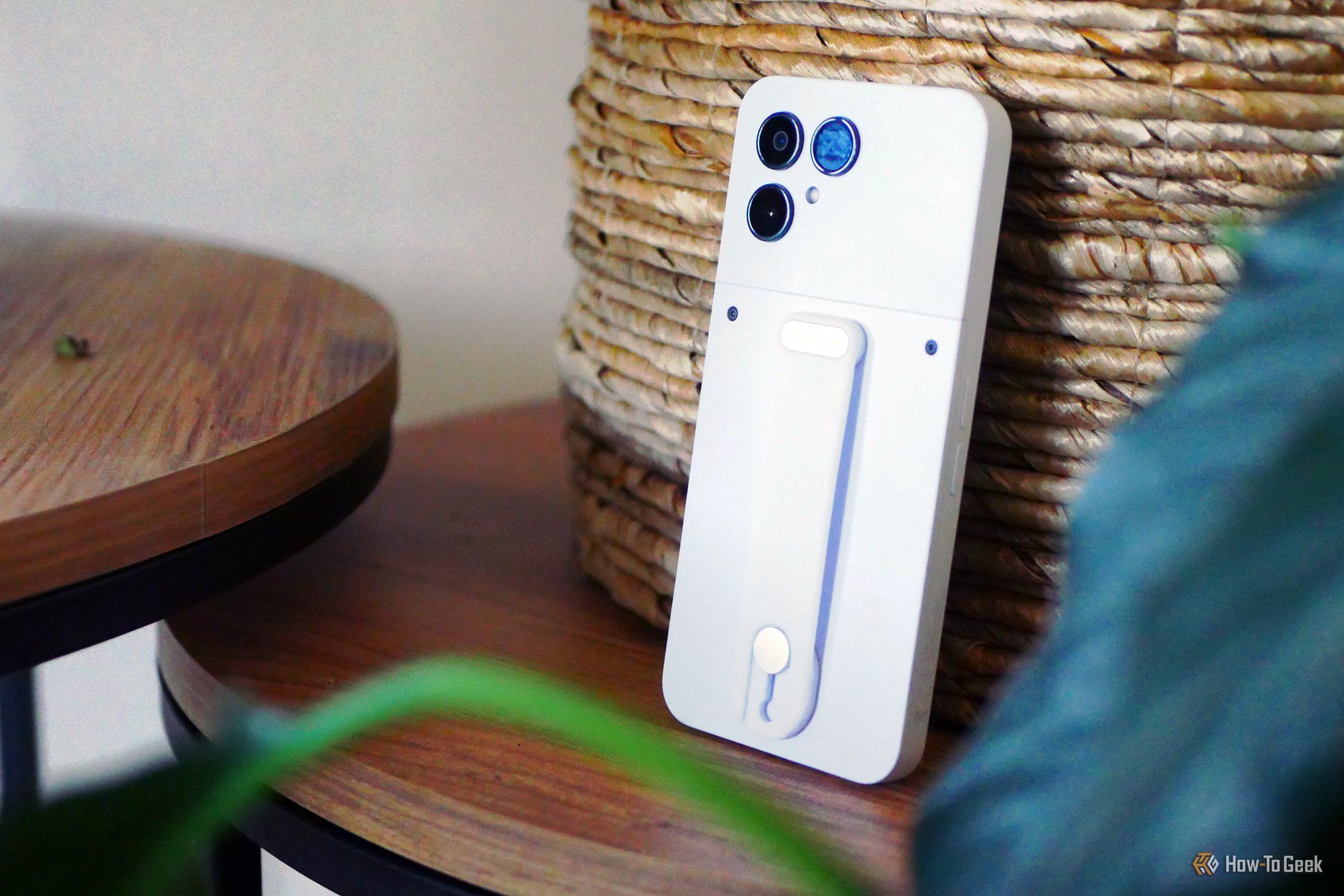 A Fairphone 6 leaning against a basket.