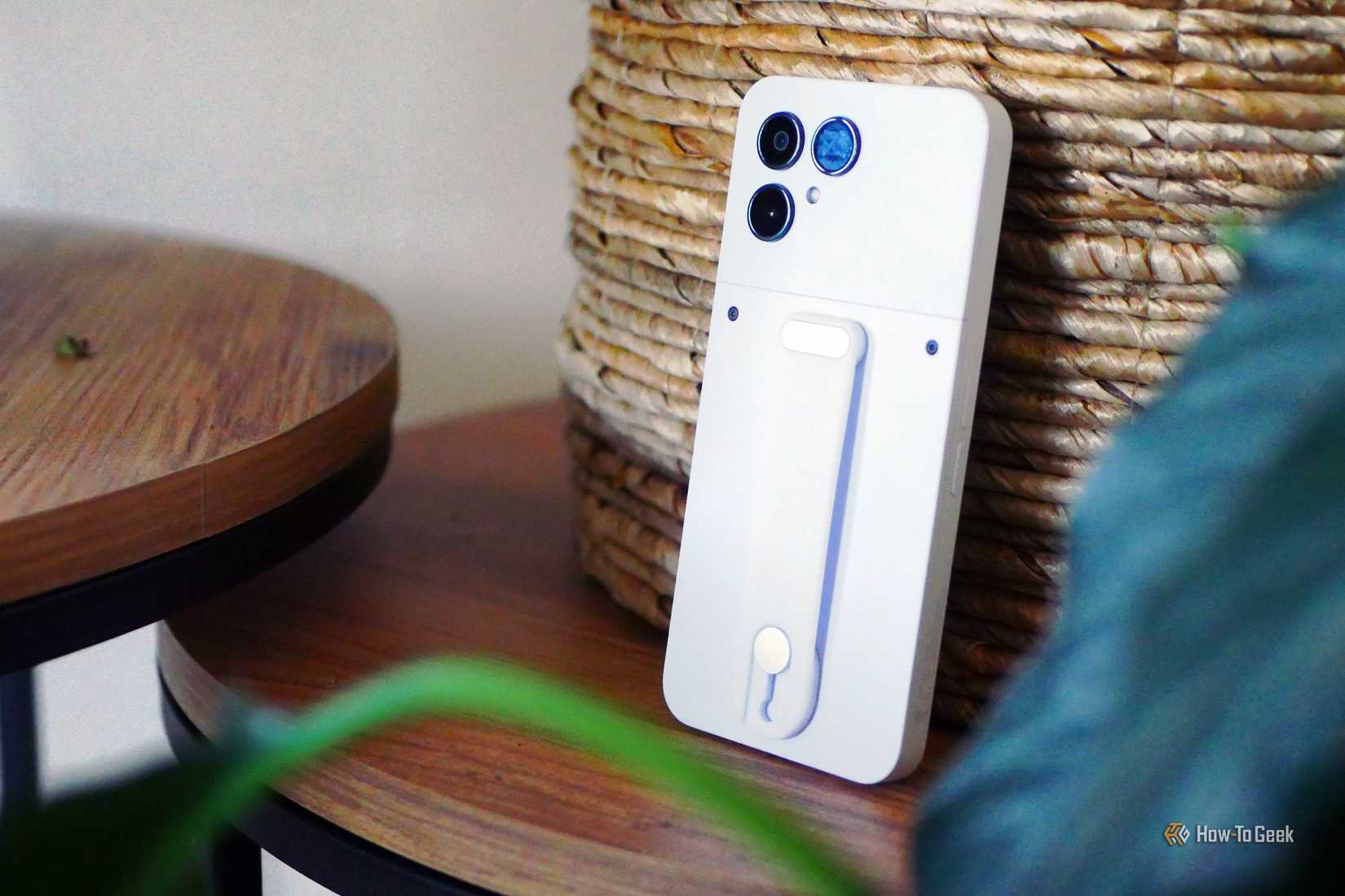 A Fairphone 6 leaning against a basket.