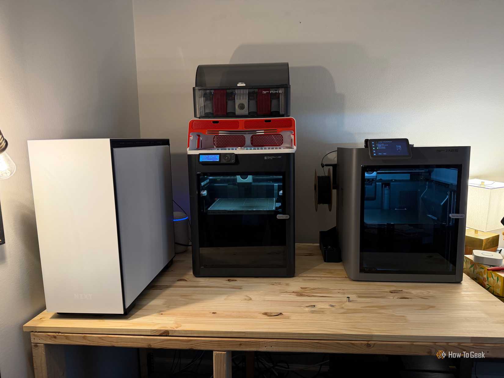 The Bambu Lab P2S and P1S sit next to each other on the table.