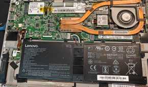 The internals of an old laptop with an old battery.