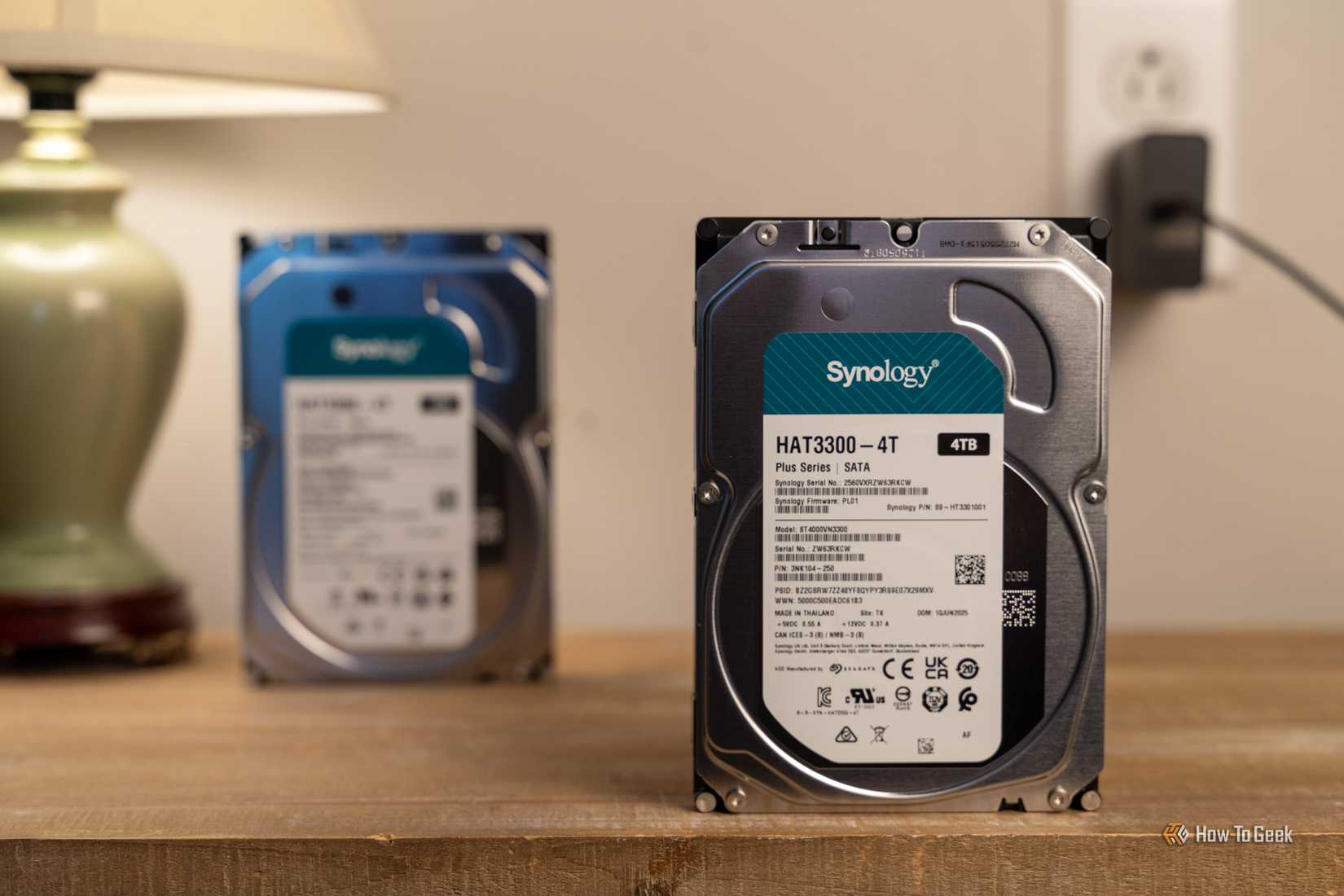 Synology HAT3300-4T 4TB hard drive standing in front of a second Synology drive.