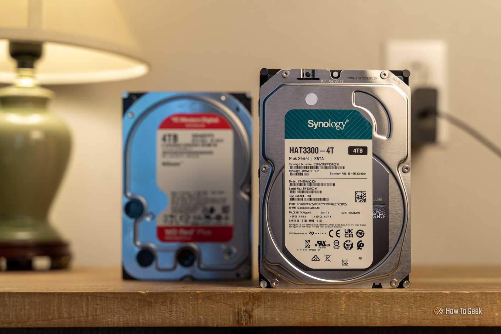 Synology HAT3300-4T 4TB hard drive with a WD Red Plus drive blurred behind it.