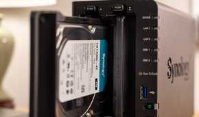 Synology HAT3300-4T hard drive partially inserted into the DS225 Plus NAS bay.