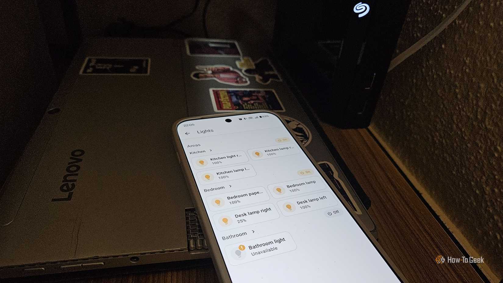 A phone running Home Assistant next to a laptop NAS.
