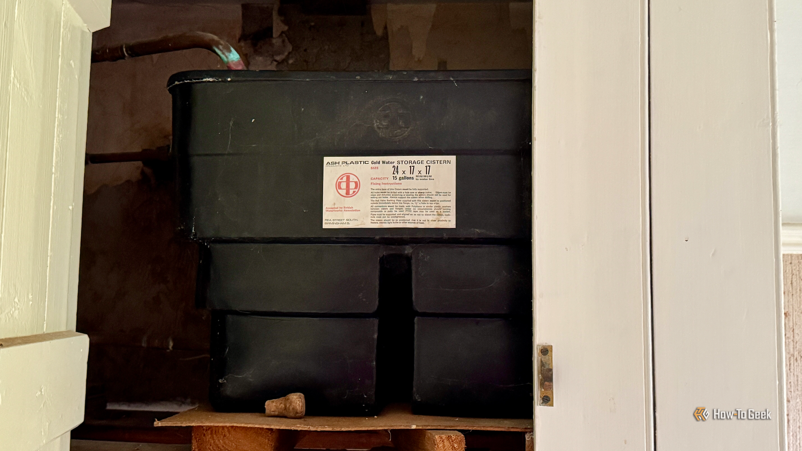 A cold water storage tank in a utility closet.