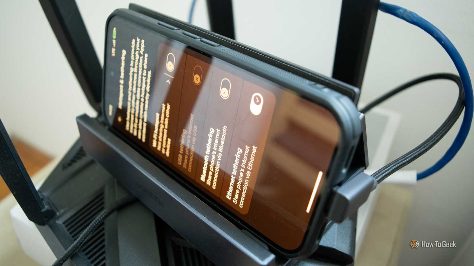 A Pixel 10 Pro phone plugged into a router via Ethernet. 