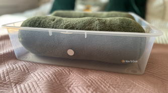 A storage bin with an NFC tag stuck to the outside of it.