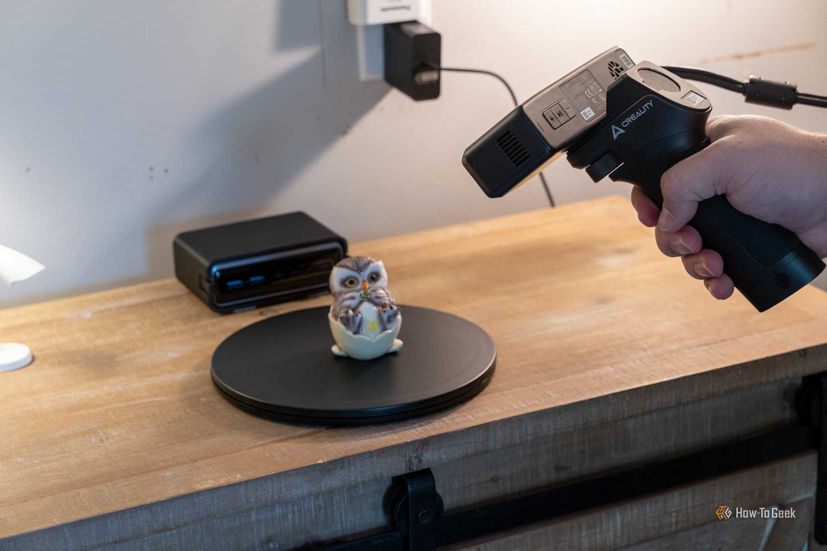 Creality 3D scanner capturing a painted owl figurine on a rotating turntable.