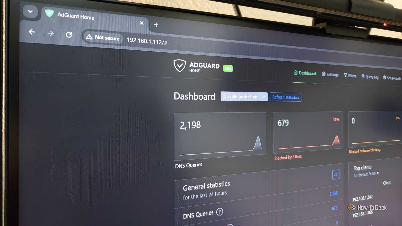 AdGuard Home dashboard being displayed on a computer monitor.