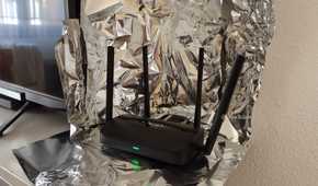 A Wi-Fi 7 router surrounded by aluminum foil.