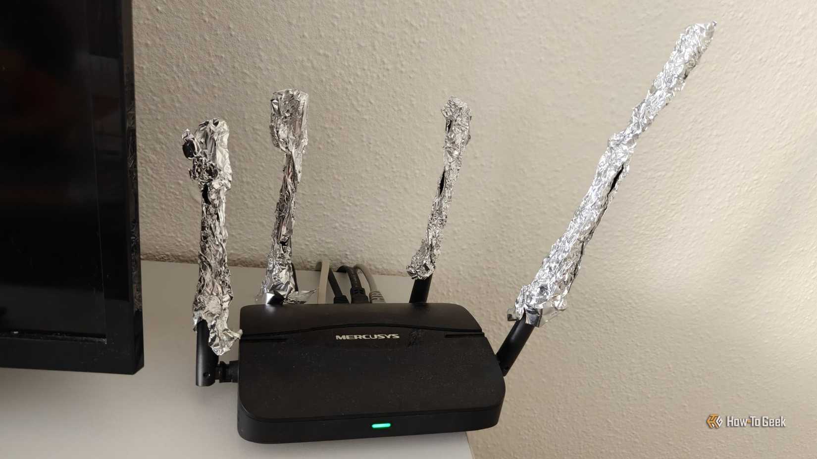 A Wi-Fi router with the antennas extended using aluminum foil.