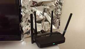 A piece of aluminum foil behind a Wi-Fi router.