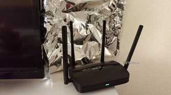 A piece of aluminum foil behind a Wi-Fi router.