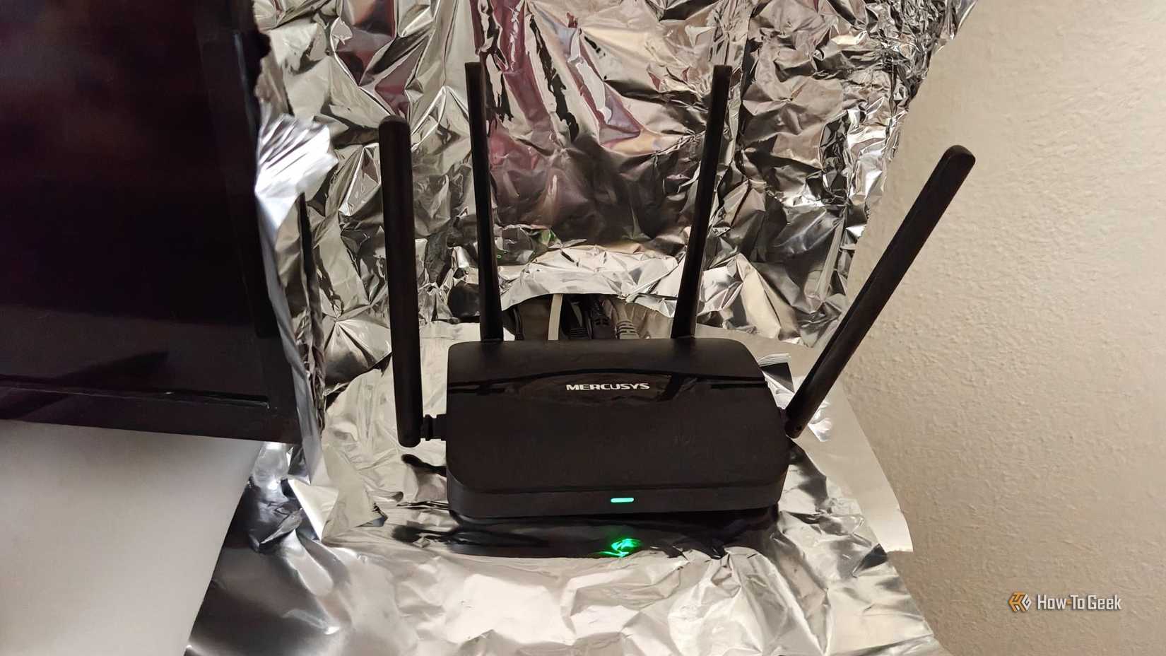 A Wi-Fi router sitting inside a partial Faraday Cage made of aluminum foil.