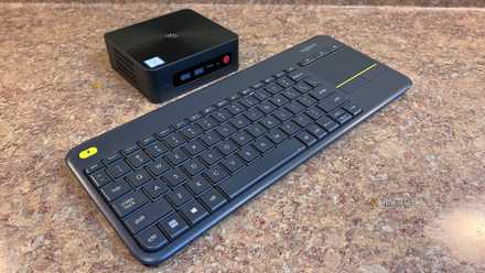 An image of a Beelink mini PC and a Logitech wireless keyboard on a counter top.