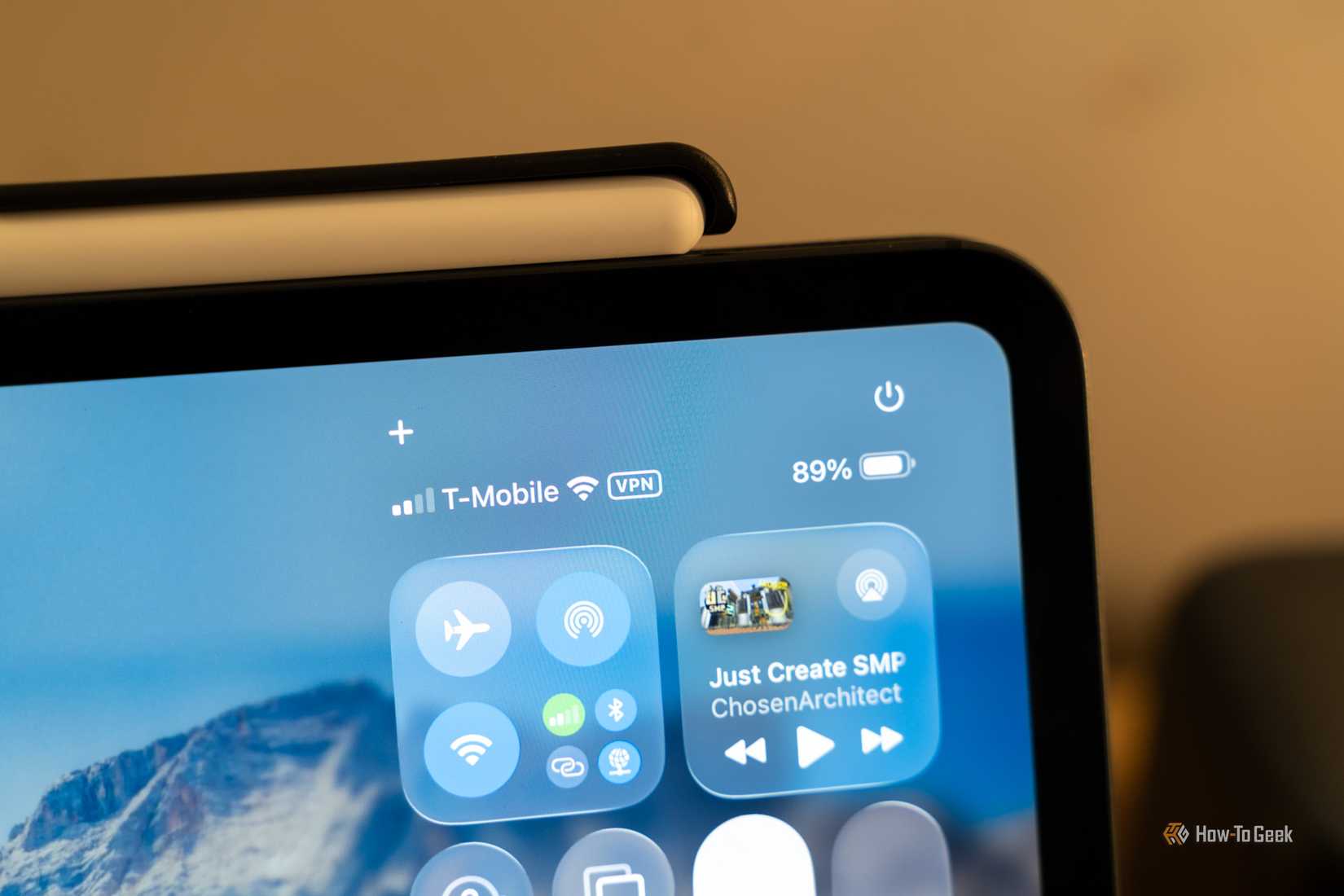 iPad Control Center showing T-Mobile Wi-Fi and VPN indicator while media plays.