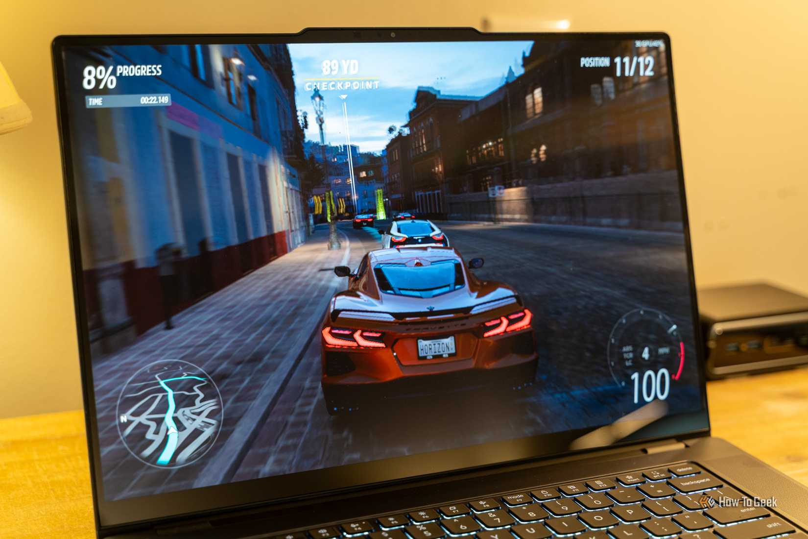Lenovo Yoga Pro 9i Aura Edition Gen 11 running a racing game on the display.