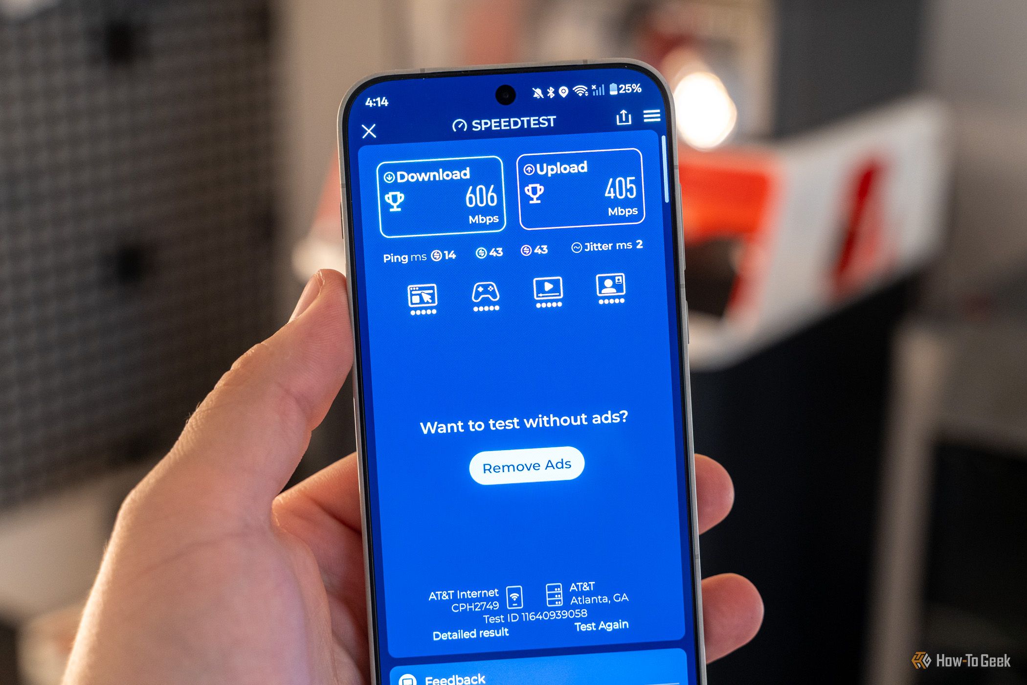 Phone showing Speedtest result with 606 Mbps download and 405 Mbps upload on AT&T.