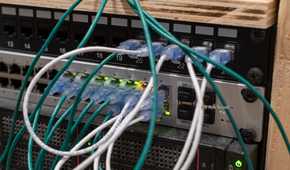 UniFi US-48-500W managed PoE network switch with Ethernet cables and SFP ports.