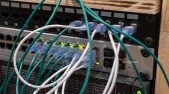 UniFi US-48-500W managed PoE network switch with Ethernet cables and SFP ports.