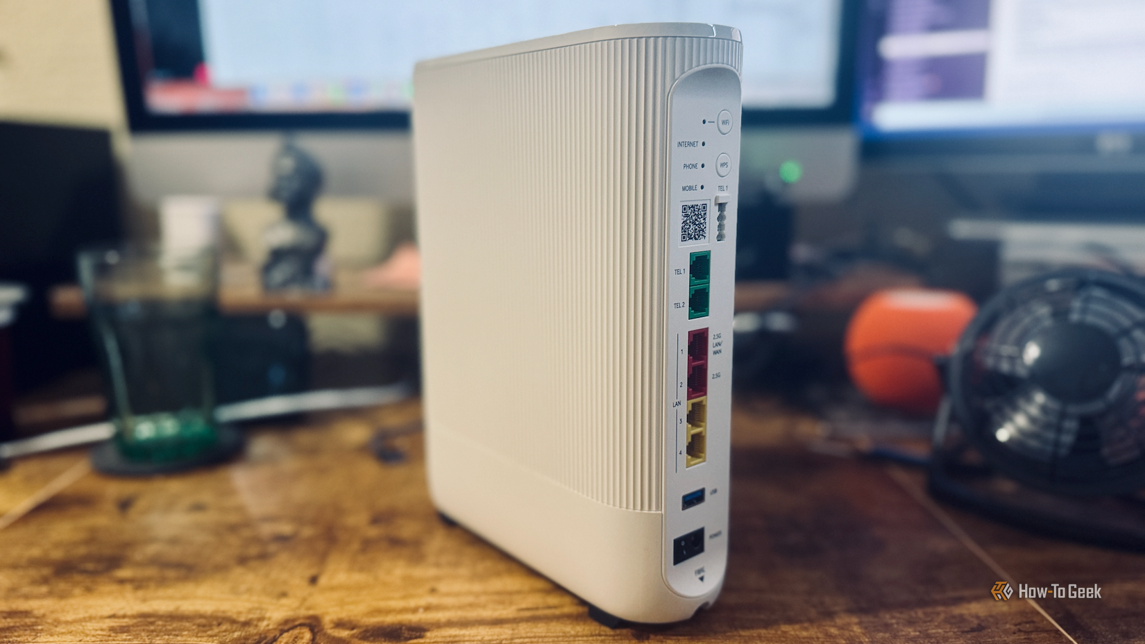 A Vodafone Ultra Hub 7 router on a desk in front of a computer.