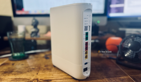 A Vodafone Ultra Hub 7 router on a desk in front of a computer.